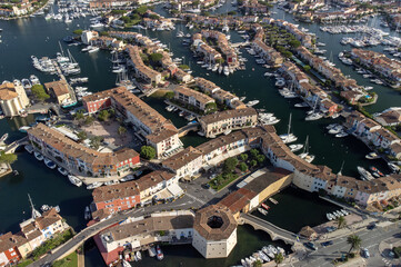 Aerial view on Gulf of Saint-Tropez, sail boats, houses of Port Grimaud and Port Cogolin, summer vacation in Provence, France