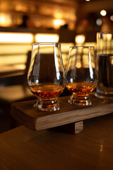 Flight of single malt scotch whisky in glasses served in whiskey bar in Edinburgh, UK