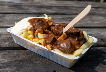 Traditional street food in Belgium, French fried potatoes with beef stew and mayonnaise