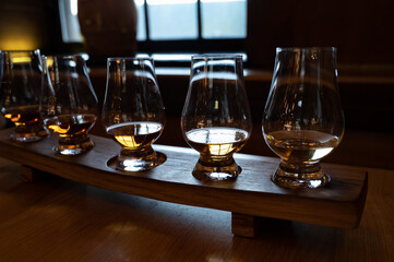 Flight of single malt scotch whisky in glasses served in whiskey bar in Edinburgh, UK
