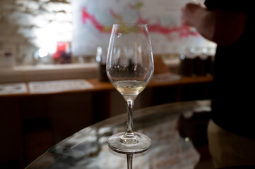 Wine tasting in underground cellars caves of French wine domain in Puligny-Motrachet village, Burgundy, France