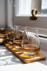 Flight of single malt scotch whisky served on old wooden window sill in Scottisch house in Edinburgh, Scotland, UK