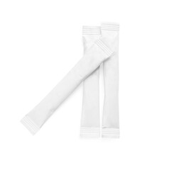 Paper sticks of sugar on white background, top view