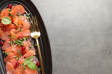 Delicious salmon carpaccio served on grey table, top view. Space for text