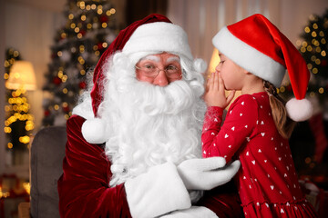Fototapeta na wymiar Little girl whispering in Santa Claus' ear near Christmas tree indoors