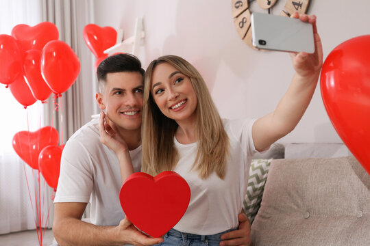 Lovely couple taking selfie at home. Valentine's day celebration
