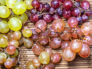 Green variety of grapes on the table. Berry harvest. Home furnishings. Kishmish on the table....