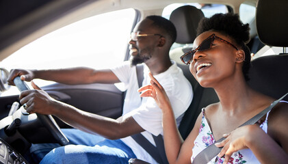 Freedom, travel and couple on a car road trip happy, singing music and driving. Black woman and man...