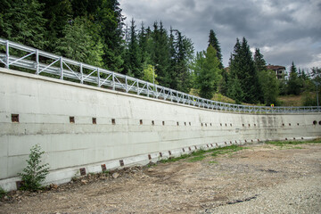 Concrete wall to support the road in the Colibita mountain area, from Bistrita, Romania, August 2022