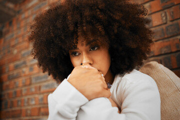 Fear, sad or depression of a young woman sitting with depressed expression or thinking of a problem. Worried and alone african American woman after a bad fail, anxiety or mental health issues - Powered by Adobe