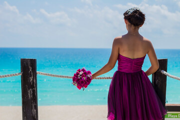 Graduated girl is on the photo session on the caribbean sea. Cancun Mexico