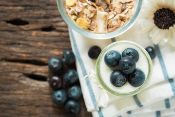 yogurt with fresh blueberry on a wooden background. healthy cereal morning breakfast,oat