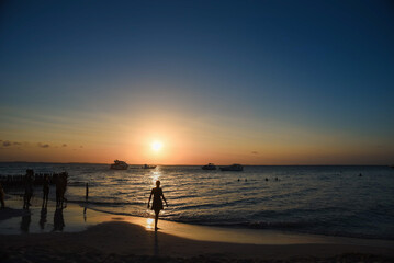 sunset on the beach, woman's shadow