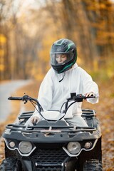 Young woman driving quad bike in autumn forest © prostooleh