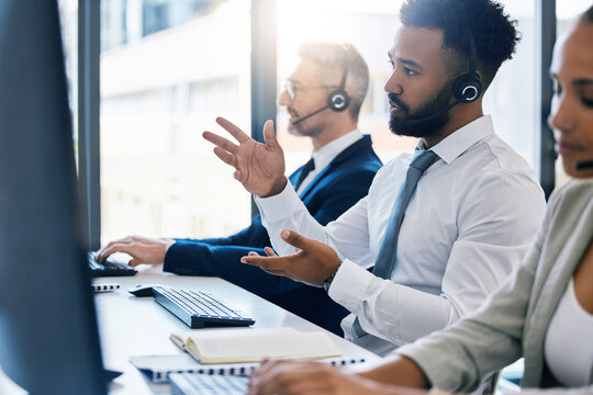 Call center, customer care and support with a man consultant in a headset working on a computer in his office. Contact us, crm and telemarketing with a male consulting on a call at his work desk