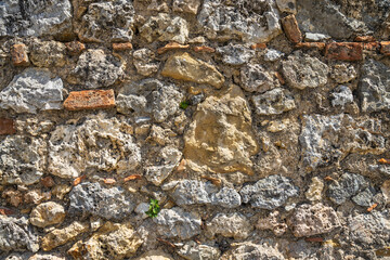 Stone wall background from the city walls of Monteriggioni in Tuscany, Italy, Europe.