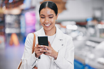 Fototapeta na wymiar Happy woman with phone reading funny social media meme on the internet while in a mall. Female with a smile while for discount coupon or texting a contact on a mobile smartphone after retail shopping
