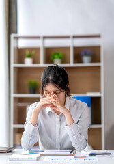 Asian women are stressed while working on laptop, Tired asian businesswoman with headache at...
