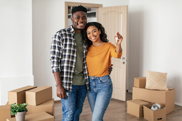 Black Husband And Wife Holding Home Key Standing Indoor