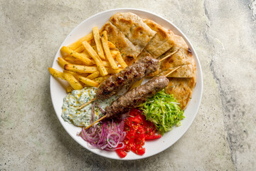 souvlaki with beef Lula kebab, french fries,vegetables and pita