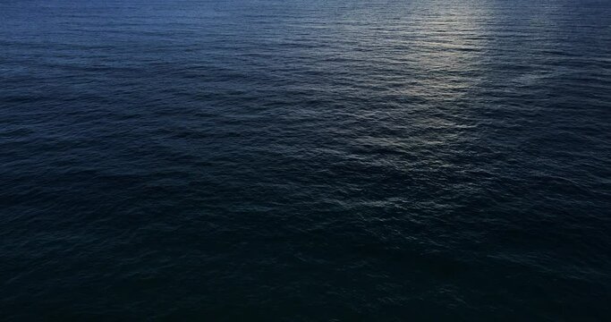 Aerial view top-down view blue ocean wave texture water surface. ProRes HQ 4:2:2 Nature and Go Everywhere travel concept.
