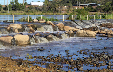 Small waterfall with rocks in a park