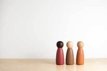 Three multicultural wooden peg dolls with copy space - Multiracial, Inclusion Concept, Montessori,...