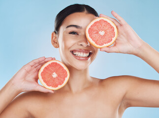 Beauty, health and woman with clear skin and a grapefruit with nutrition and vitamins in a studio....