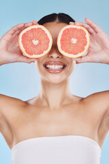 Grapefruit for skincare, beauty cosmetic and healthy product with nutrition for face against blue mockup studio background. Natural dental wellness, fruit for clean body and smile by happy model