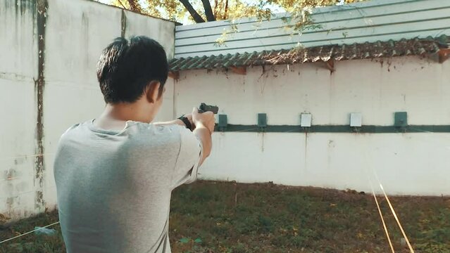 Man shooting pistol handgun weapon