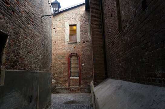 View of an alley around the Church of Santa Maria Assunta, early in the morning . Chivasso, Piedmont, Italy.