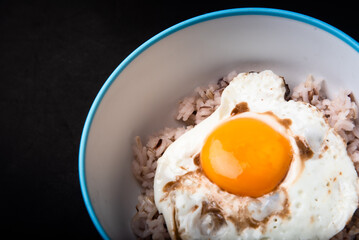 street food, fried egg, fried egg, oil-free fried egg, slow cooker, healthy technology, healthy technology, on the background, black background, wooden floor, high resolution photo