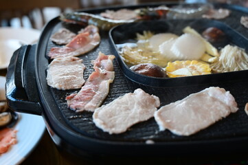 barbecue gril on black pot with meat and vegetable