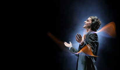 Young businessman with headphones . Mixed media