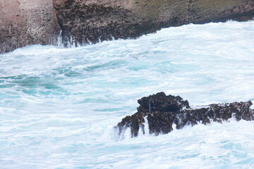 Sea waves greets the rocks at the beach