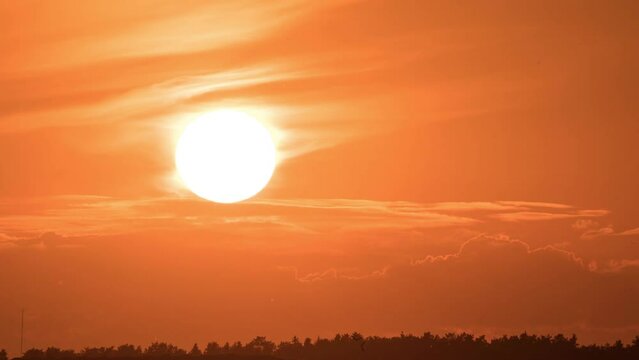 Sunset Close-up time lapse. Big sun with clouds. Beautiful red sunset