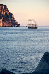 classic sailboat anchored in the bay at sunrise - 528840020