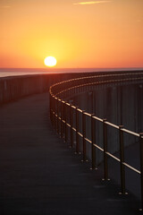 abstract shapes with light and shadow at sunrise on concrete walkway - 528840022