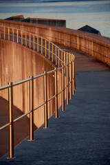 abstract shapes with light and shadow at sunrise on concrete walkway - 528840024