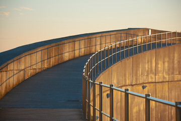 abstract shapes with light and shadow at sunrise on concrete walkway - 528840030