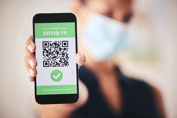 Covid passport, QR code and phone in the hand of a woman refugee or passenger ready for immigration and travel. Closeup of 5g mobile technology for safety during the global corona virus epidemic