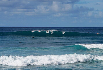 Surfers at Banzai Pipeline in Kauai Hawaii