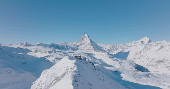 Aerial drone flyover Gornergrat with Matterhorn view during winter in Switzerland. Majestic mountain peaks iconic famous zermatt travel ski resort in the alps. Wonderful inspiring nature landscape.