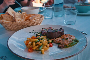 Various meat and vegetables on the table in restaurant