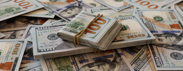 Bundles of One Hundred Dollar Bills on Scattered Banknotes. Prosperity concept.