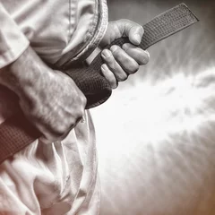 Papier Peint photo Lavable Arts martiaux Midsection of martial artist tying black belt
