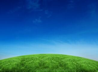 Green hill under blue sky