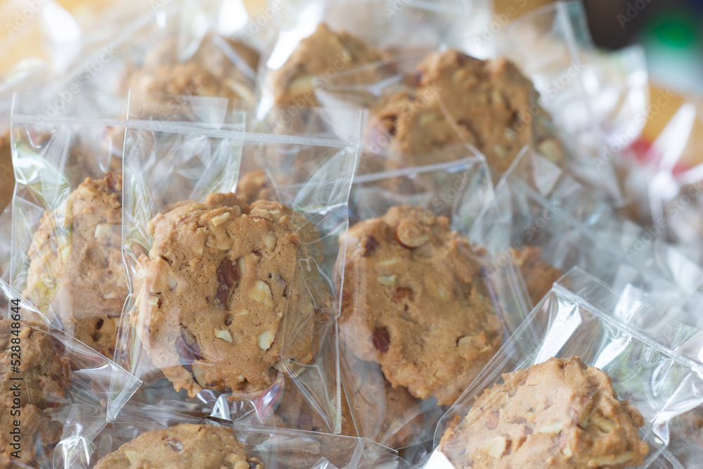 Wall mural Homemade cookie in plastic bag package with close up shot,food packaging concept.