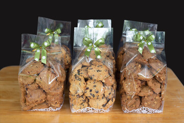 Homemade cookie in plastic bag with ribbon bow tie, food packaging concept.