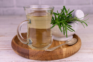 Fresh rosemary tea. Herbal tea in a transparent cup.
